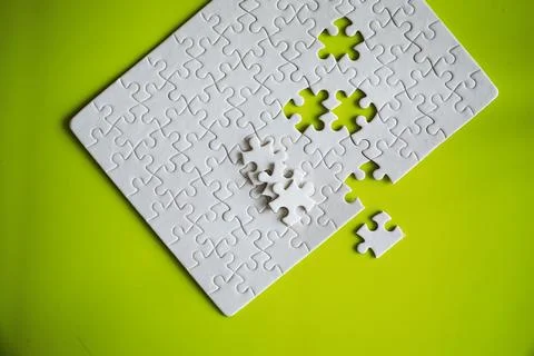 Clean puzzle elements on the background. Empty puzzle piece on the table. T.. 库存照片