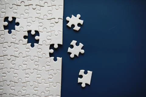 Clean puzzle elements on the background. Empty puzzle piece on the table. T.. 스톡 사진