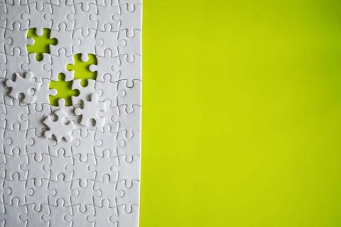 Clean puzzle elements on the background. Empty puzzle piece on the table. T.. Stock Photos