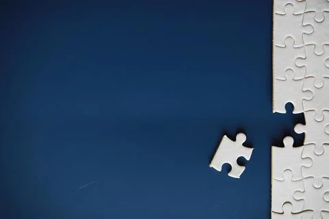 Clean puzzle elements on the background. Empty puzzle piece on the table. T.. Stock Photos
