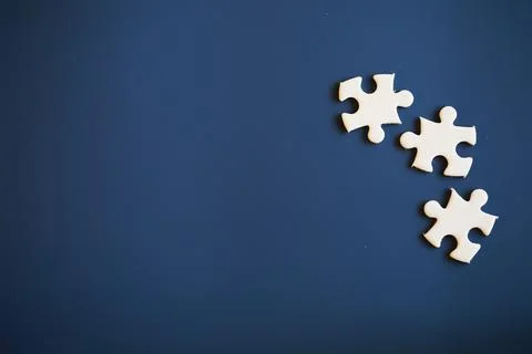 Clean puzzle elements on the background. Empty puzzle piece on the table. T.. Stock Photos