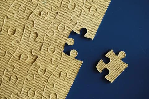 Clean puzzle elements on the background. Empty puzzle piece on the table. T.. Stock Photos