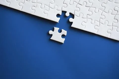 Clean puzzle elements on the background. Empty puzzle piece on the table. T.. Stock Photos