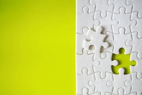 Clean puzzle elements on the background. Empty puzzle piece on the table. T.. Stock Photos