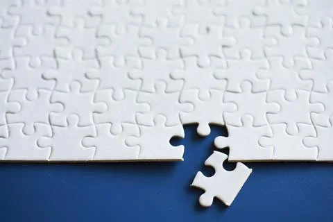 Clean puzzle elements on the background. Empty puzzle piece on the table. T.. Stock Photos