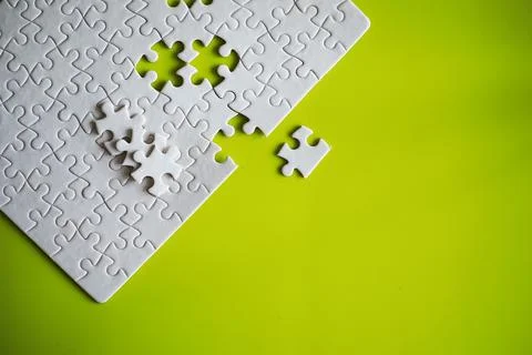 Clean puzzle elements on the background. Empty puzzle piece on the table. T.. 스톡 사진