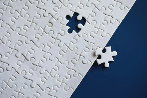 Clean puzzle elements on the background. Empty puzzle piece on the table. T.. Stock Photos