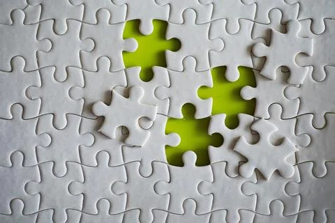 Clean puzzle elements on the background. Empty puzzle piece on the table. T.. Stock Photos