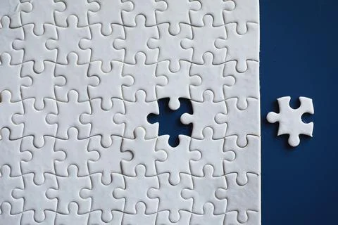 Clean puzzle elements on the background. Empty puzzle piece on the table. T.. Stock Photos