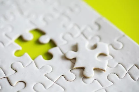 Clean puzzle elements on the background. Empty puzzle piece on the table. T.. 스톡 사진