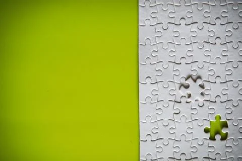 Clean puzzle elements on the background. Empty puzzle piece on the table. T.. Stock Photos