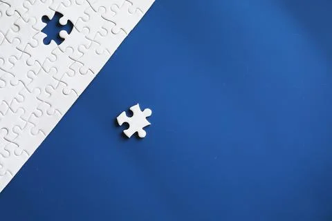 Clean puzzle elements on the background. Empty puzzle piece on the table. T.. Stock Photos