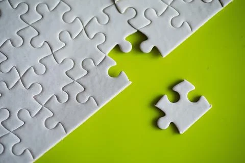 Clean puzzle elements on the background. Empty puzzle piece on the table. T.. 스톡 사진