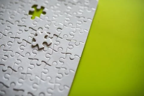 Clean puzzle elements on the background. Empty puzzle piece on the table. T.. Stock Photos