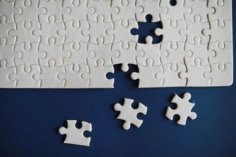 Clean puzzle elements on the background. Empty puzzle piece on the table. T.. Stock Photos