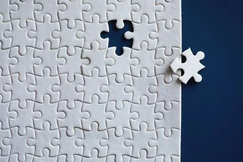 Clean puzzle elements on the background. Empty puzzle piece on the table. T.. Stock Photos