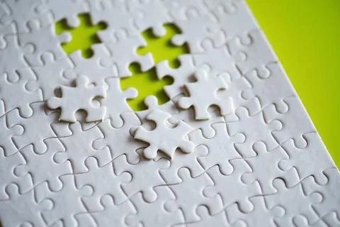 Clean puzzle elements on the background. Empty puzzle piece on the table. T.. Stock Photos