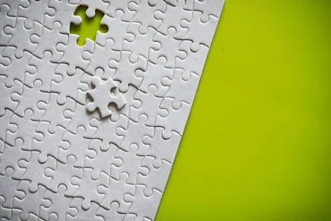 Clean puzzle elements on the background. Empty puzzle piece on the table. T.. Stock Photos