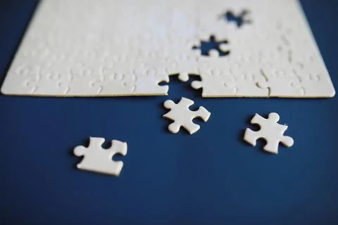 Clean puzzle elements on the background. Empty puzzle piece on the table. T.. Stock Photos