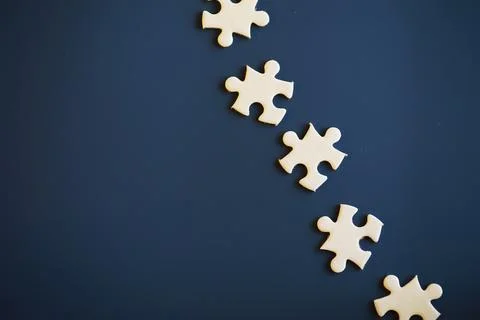 Clean puzzle elements on the background. Empty puzzle piece on the table. T.. 스톡 사진