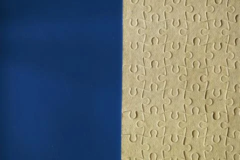 Clean puzzle elements on the background. Empty puzzle piece on the table. T.. Stock Photos