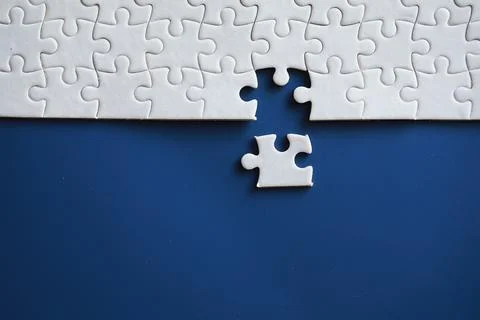 Clean puzzle elements on the background. Empty puzzle piece on the table. T.. Stock Photos