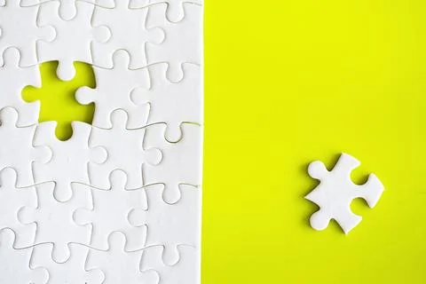 Clean puzzle elements on the background. Empty puzzle piece on the table. T.. 스톡 사진
