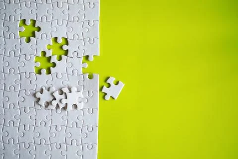 Clean puzzle elements on the background. Empty puzzle piece on the table. T.. Stock Photos