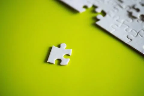 Clean puzzle elements on the background. Empty puzzle piece on the table. T.. Stock Photos