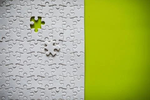 Clean puzzle elements on the background. Empty puzzle piece on the table. T.. Stock Photos
