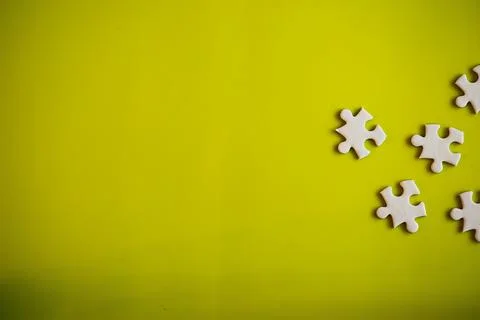 Clean puzzle elements on the background. Empty puzzle piece on the table. T.. Stock Photos