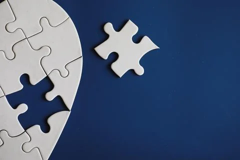 Clean puzzle elements on the background. Empty puzzle piece on the table. T.. Stock Photos