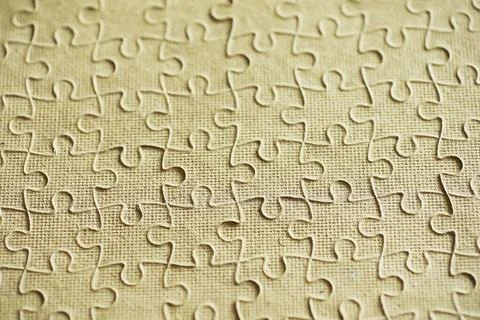 Clean puzzle elements on the background. Empty puzzle piece on the table. T.. Stock Photos