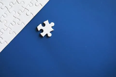 Clean puzzle elements on the background. Empty puzzle piece on the table. T.. Stock Photos