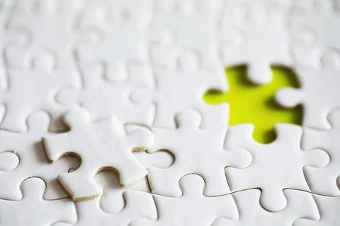 Clean puzzle elements on the background. Empty puzzle piece on the table. T.. 库存照片