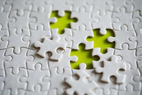 Clean puzzle elements on the background. Empty puzzle piece on the table. T.. Stock Photos