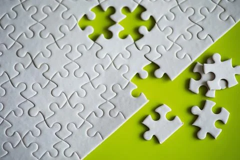 Clean puzzle elements on the background. Empty puzzle piece on the table. T.. Stock Photos