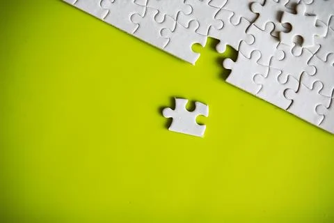 Clean puzzle elements on the background. Empty puzzle piece on the table. T.. Stock Photos