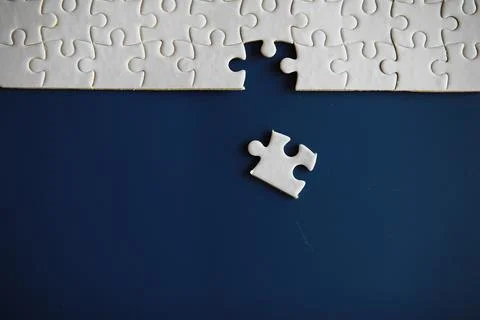 Clean puzzle elements on the background. Empty puzzle piece on the table. T.. Stock Photos