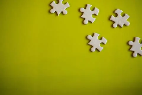 Clean puzzle elements on the background. Empty puzzle piece on the table. T.. 스톡 사진