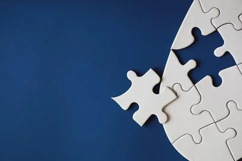 Clean puzzle elements on the background. Empty puzzle piece on the table. T.. Stock Photos
