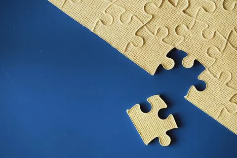 Clean puzzle elements on the background. Empty puzzle piece on the table. T.. Stock Photos