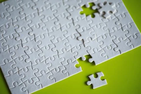 Clean puzzle elements on the background. Empty puzzle piece on the table. T.. Stock Photos