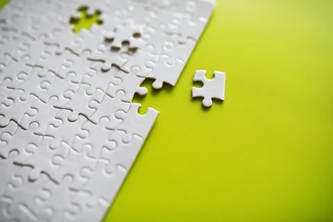 Clean puzzle elements on the background. Empty puzzle piece on the table. T.. 스톡 사진