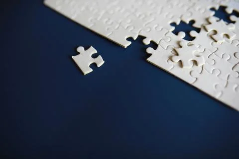 Clean puzzle elements on the background. Empty puzzle piece on the table. T.. 스톡 사진