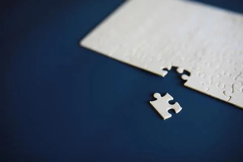 Clean puzzle elements on the background. Empty puzzle piece on the table. T.. Stock Photos
