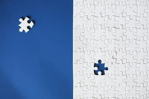Clean puzzle elements on the background. Empty puzzle piece on the table. T.. Stock Photos