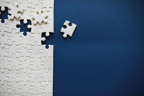 Clean puzzle elements on the background. Empty puzzle piece on the table. T.. Stock Photos