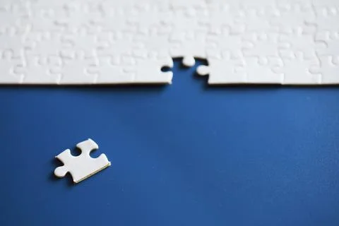 Clean puzzle elements on the background. Empty puzzle piece on the table. T.. Stock Photos