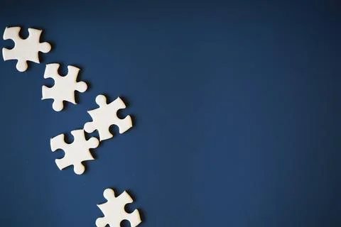 Clean puzzle elements on the background. Empty puzzle piece on the table. T.. Stock Photos